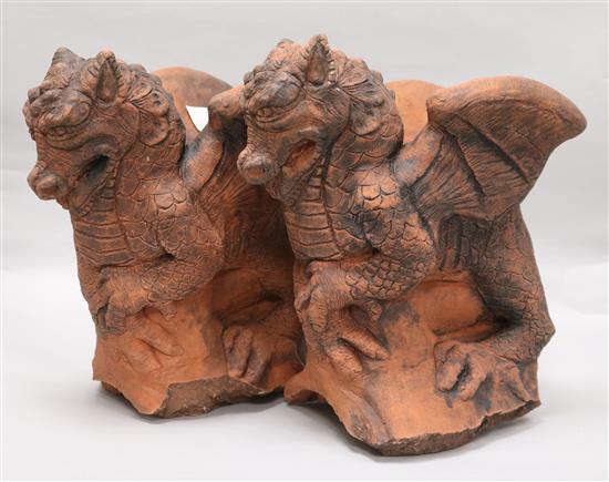 A pair of moulded terracotta griffins H.30cm x W.28cm